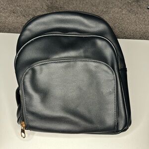 black backpack purse with gold zippers
